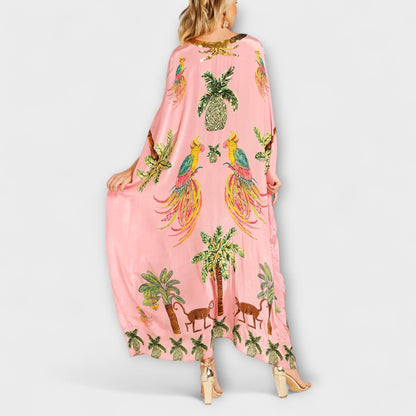Linda - Iögonfallande klänning med off-shoulder-design och kokosnötsträdsmönster